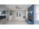 Bright living room with doors to the deck, a painted brick fireplace and light-colored hardwood floors at 1013 Doby Springs Dr, Charlotte, NC 28262