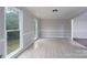 Sunlit room with hardwood floors and large windows provides natural light and a backyard view at 1013 Doby Springs Dr, Charlotte, NC 28262
