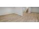 Spacious basement with wood-look flooring and bright white walls at 1015 4Th St, Spencer, NC 28159