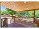 Covered porch with wood ceiling overlooking the pool and backyard at 1015 4Th St, Spencer, NC 28159