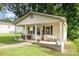 Inviting front porch with a white bench and cozy seating, perfect for relaxing outdoors at 1016 W 10Th Ave, Gastonia, NC 28052