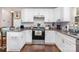 Bright kitchen featuring white cabinets, granite countertops, and modern appliances at 1016 W 10Th Ave, Gastonia, NC 28052