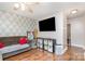 Cozy living room featuring modern decor, a large television, and wood flooring at 1016 W 10Th Ave, Gastonia, NC 28052