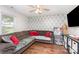 Comfortable living room features an L-shaped couch, accent pillows, and wood flooring at 1016 W 10Th Ave, Gastonia, NC 28052