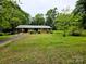 Charming single-story brick home with a carport and mature trees, offering a serene setting at 1105 Stanton Dr, Shelby, NC 28150
