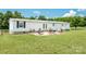 Back view of house with a concrete patio surrounded by green grass at 1107 Richard Rd, Salisbury, NC 28147
