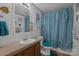 Bathroom featuring a vanity, toilet, mirror, and shower with blue accents at 1107 Richard Rd, Salisbury, NC 28147