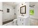 Bathroom featuring a tiled shower, marble tile floors, a white vanity, and an updated mirror at 1155 Cedar Grove Ln, Rock Hill, SC 29732