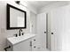 Bathroom featuring a black-framed mirror, white vanity, and matte black hardware for a modern look at 1155 Cedar Grove Ln, Rock Hill, SC 29732
