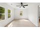 Bright bedroom featuring a ceiling fan, three windows providing natural light, and light wood flooring at 1155 Cedar Grove Ln, Rock Hill, SC 29732