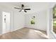 Bright bedroom featuring wood-look flooring, a ceiling fan, and a window with a view of greenery at 1155 Cedar Grove Ln, Rock Hill, SC 29732