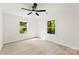 Bright bedroom featuring wood-look flooring, two windows with tree views, and a modern ceiling fan at 1155 Cedar Grove Ln, Rock Hill, SC 29732