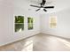 Bright bedroom featuring a ceiling fan, three windows, white walls, and light wood flooring at 1155 Cedar Grove Ln, Rock Hill, SC 29732
