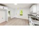 Bright kitchen featuring white cabinets, granite counters, stainless steel sink, and light wood flooring at 1155 Cedar Grove Ln, Rock Hill, SC 29732