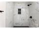 Modern shower featuring white marble-style tile and dark fixtures, including a convenient built-in niche at 1155 Cedar Grove Ln, Rock Hill, SC 29732