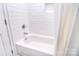Bathroom with all-white tile shower with new fixtures at 11772 Sugar Hill Rd, Davidson, NC 28036