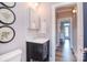 Charming bathroom featuring a black vanity with marble countertop and decorative artwork at 11772 Sugar Hill Rd, Davidson, NC 28036