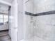 Modern bathroom shower stall with marble tile and decorative inset at 11772 Sugar Hill Rd, Davidson, NC 28036