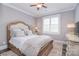 Comfortable bedroom with a wooden bed frame, soft bedding, and a ceiling fan at 11772 Sugar Hill Rd, Davidson, NC 28036