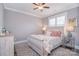 Comfortable bedroom with a wooden sleigh bed, soft bedding, and a ceiling fan at 11772 Sugar Hill Rd, Davidson, NC 28036