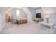 Bright bonus room featuring neutral walls and carpet with bedroom set and desk at 11772 Sugar Hill Rd, Davidson, NC 28036