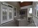Comfortable covered patio with wicker seating and TV at 11772 Sugar Hill Rd, Davidson, NC 28036