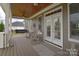 Relaxing covered porch with comfortable rocking chairs and a swing at 11772 Sugar Hill Rd, Davidson, NC 28036