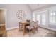 Dining area with large clock, french doors to the outside with an open view to the living room at 11772 Sugar Hill Rd, Davidson, NC 28036