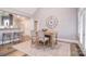 Dining area with large clock, french doors and an open view to the kitchen featuring barstool seating at 11772 Sugar Hill Rd, Davidson, NC 28036