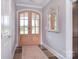 Elegant foyer featuring a double-door entrance, hardwood floors, and a decorative mirror for a welcoming ambiance at 11772 Sugar Hill Rd, Davidson, NC 28036