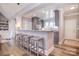 Modern kitchen with gray cabinets and stone countertops, featuring seating at the island barstool area at 11772 Sugar Hill Rd, Davidson, NC 28036
