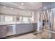 Kitchen showcasing stainless steel appliances, including a dishwasher and refrigerator, complemented by gray cabinetry at 11772 Sugar Hill Rd, Davidson, NC 28036