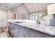 Modern kitchen with light countertops, stainless steel dishwasher, ample cabinet space and an eat-in bar at 11772 Sugar Hill Rd, Davidson, NC 28036