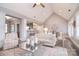 Open-concept living room with hardwood floors, neutral decor, and seamless flow to the kitchen and dining areas at 11772 Sugar Hill Rd, Davidson, NC 28036