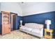 Comfortable living room featuring navy blue wood-paneled walls and a tufted sofa at 11772 Sugar Hill Rd, Davidson, NC 28036