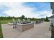 Outdoor entertaining space with a fire pit and swimming pool at 11772 Sugar Hill Rd, Davidson, NC 28036
