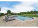 Relaxing pool area featuring lounge chairs and a hot tub at 11772 Sugar Hill Rd, Davidson, NC 28036