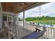 Cozy screened porch with swing and ceiling fans overlooking the pool at 11772 Sugar Hill Rd, Davidson, NC 28036