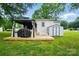 Backyard with a patio, gazebo, grill, shed, lush grass, and mature trees at 118 Globe St, Mount Holly, NC 28120