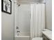 Modern bathroom featuring a tiled shower-tub combo with a white shower curtain at 118 Globe St, Mount Holly, NC 28120