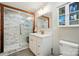 Bright bathroom with a marble tiled shower, modern vanity, and storage at 118 Globe St, Mount Holly, NC 28120