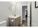 Modern bathroom featuring a gray vanity with white countertops and a view to the other room at 118 Globe St, Mount Holly, NC 28120