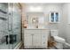 Modern bathroom featuring a marble tiled shower and storage cabinet at 118 Globe St, Mount Holly, NC 28120
