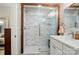 Bathroom featuring a marble tiled shower with a glass door and updated fixtures at 118 Globe St, Mount Holly, NC 28120