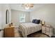 Cozy bedroom featuring a ceiling fan, wood-look floors, and a nicely decorated space at 118 Globe St, Mount Holly, NC 28120