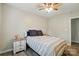 A comfortable bedroom featuring wood-look floors, a ceiling fan, and a queen sized bed at 118 Globe St, Mount Holly, NC 28120