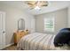 A well-lit bedroom featuring wood-look floors, a ceiling fan, and neutral colors at 118 Globe St, Mount Holly, NC 28120