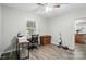 A home office or bedroom featuring wood-look floors and a ceiling fan at 118 Globe St, Mount Holly, NC 28120