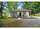 Charming home featuring a welcoming front porch, fresh landscaping, and a mix of modern and traditional design elements at 118 Globe St, Mount Holly, NC 28120