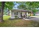 Charming home featuring a welcoming front porch, fresh landscaping, and a mix of modern and traditional design elements at 118 Globe St, Mount Holly, NC 28120